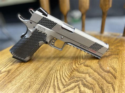The Platypus 17 is a modern beast that blends classic 1911 features with Glock 17 firepower. It has a gray-black hue, a flared magwell, a round trigger guard, and an RMR Red Dot Optic Cut Slide.